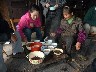 Oil tea put in bowls and extra items rice sweet corn etc are added
